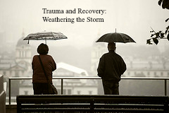 Trauma Therapy - Trauma Recovery: Weathering the Storm - Two umbrellas in black and white rain