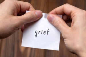 Greenwood Counseling Center grief paper being ripped in half