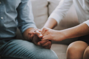 Greenwood Counseling Center couple in therapy holding hands