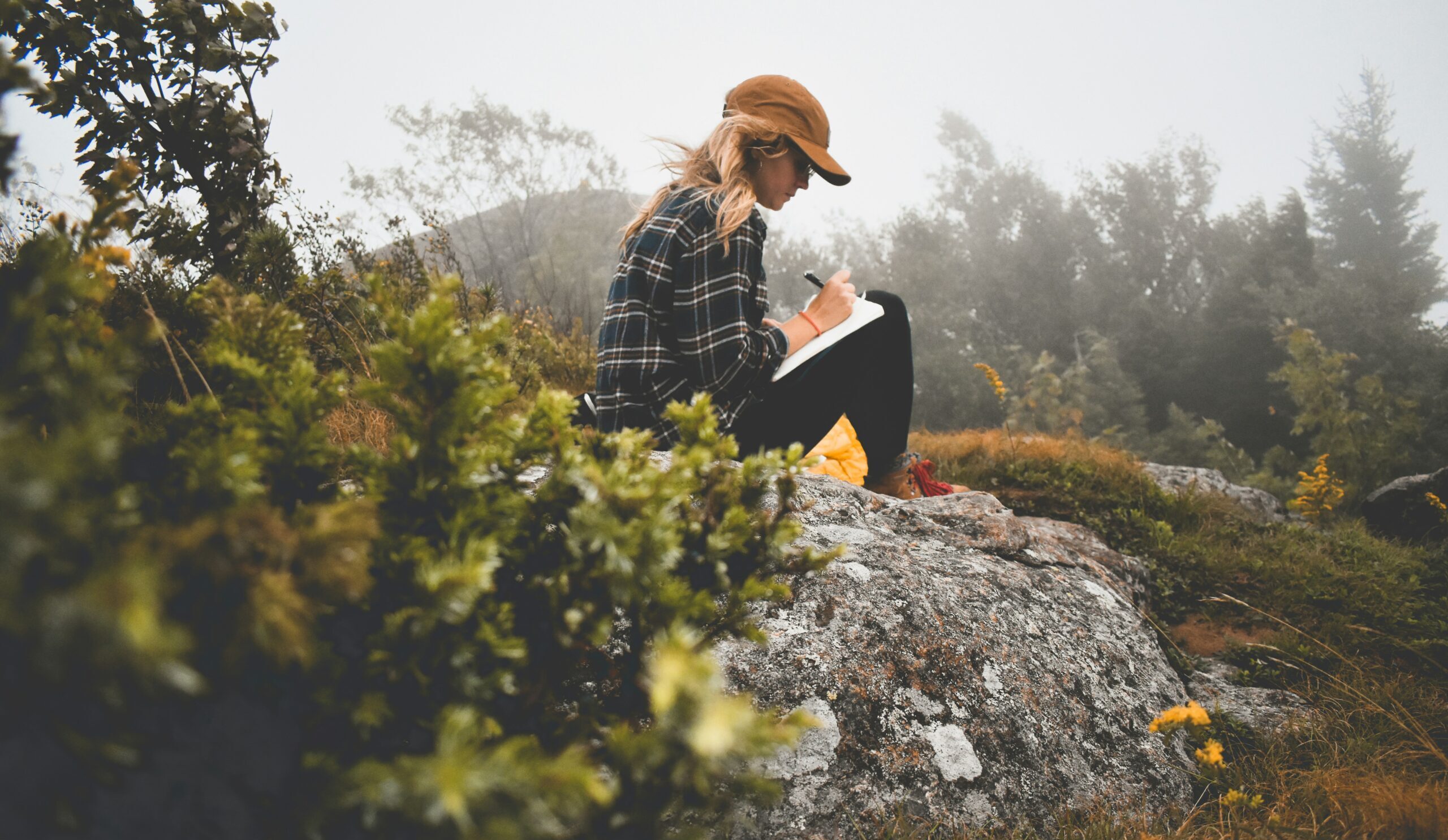Person journaling to help change anxious thinking patterns using CBT techniques.